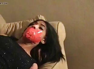 Black woman tied up and gagged with red tape