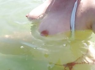 Public beach flashing boobs... tits floating free in the water
