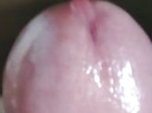 Close-up demonstration of penis and wet head from excitement